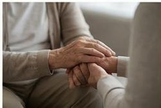 Hands clasped in comfort and support